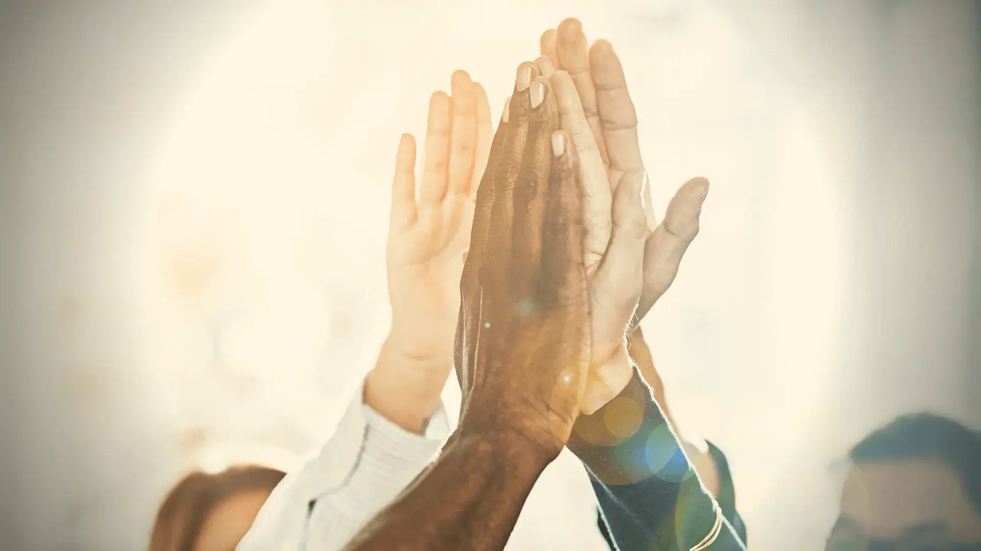 Hands raised in applause, symbolizing recognition and celebration of SPECTRAFORCE's excellence, as honored by KellyOCG®.