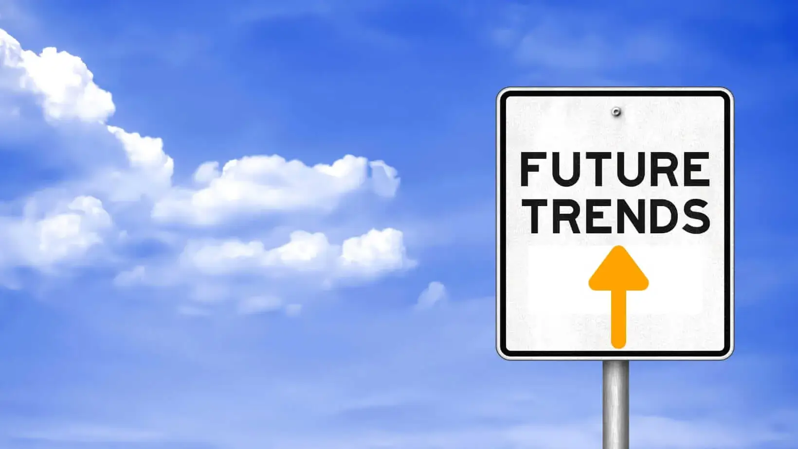 Road sign reading "FUTURE TRENDS" with an upward arrow, set against a bright blue sky with clouds, symbolizing career growth and direction.