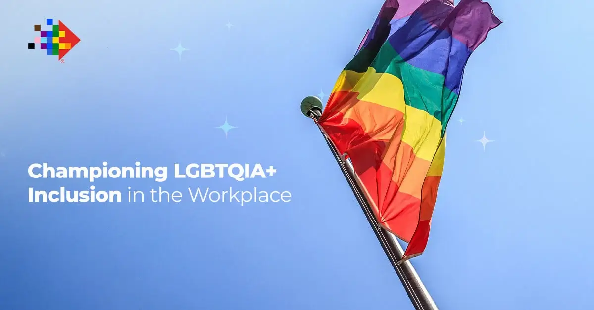Rainbow pride flag waving under blue sky, promoting LGBTQIA+ inclusion and diversity in the workplace.