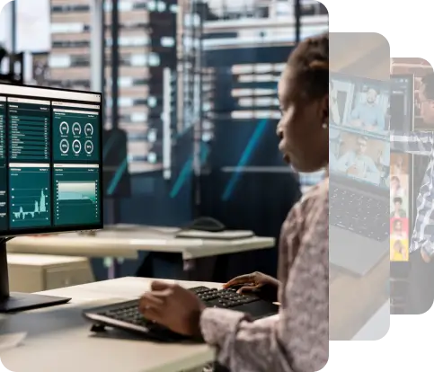 A person analyzing data on multiple computer screens in a modern office setting, surrounded by sleek furniture and technology.