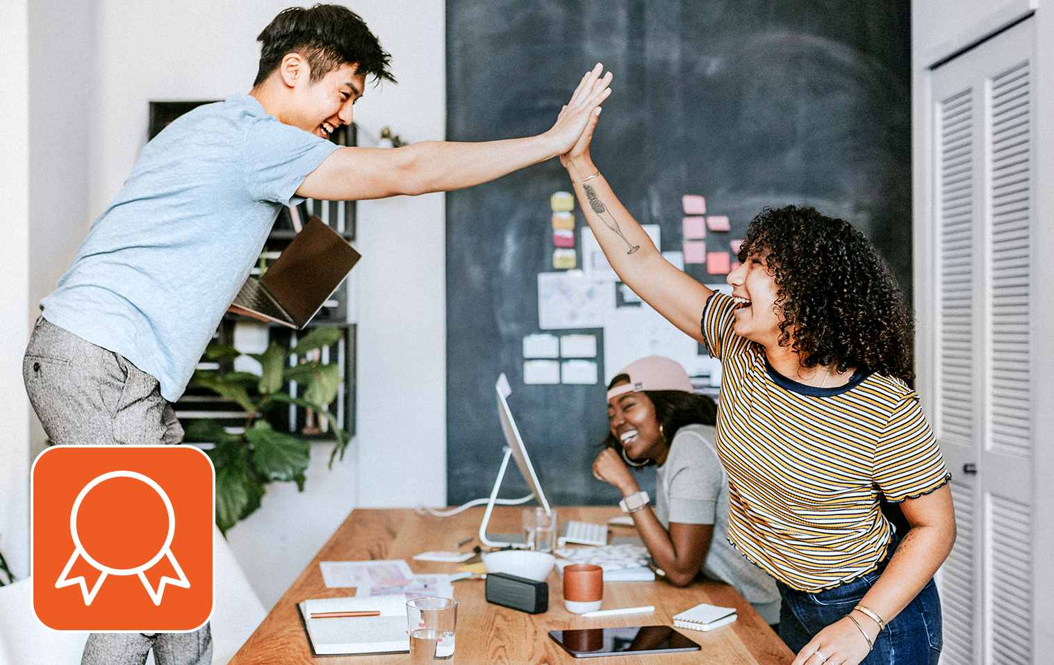 Teammates high-fiving in a joyous mood