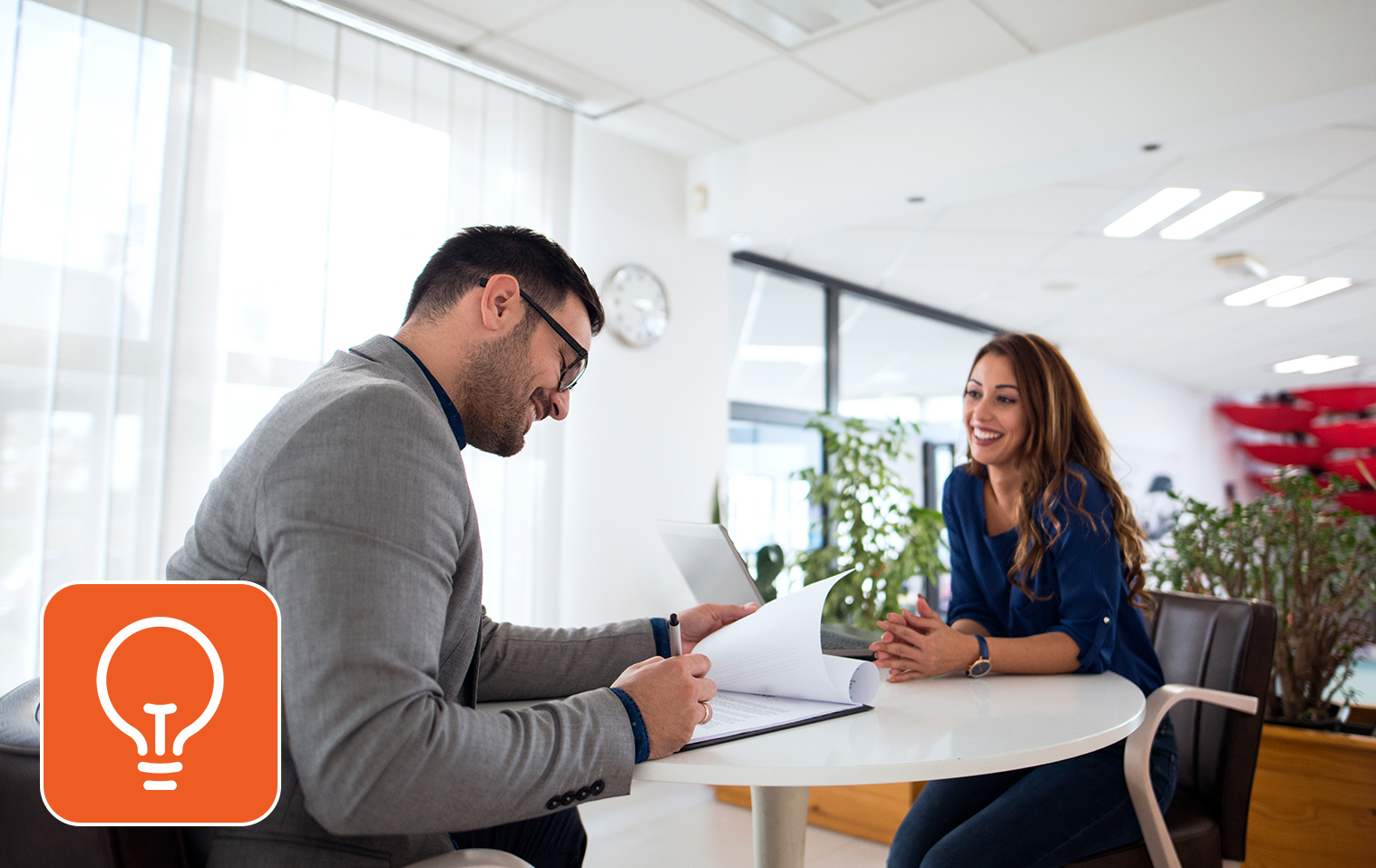 Two people discussing work in an office setting
