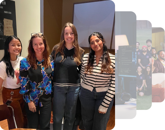 A group of colleagues smiling and posing for the picture against an office backdrop