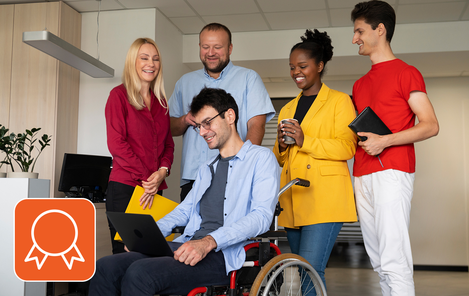 Diverse team collaborates around laptop, smiling