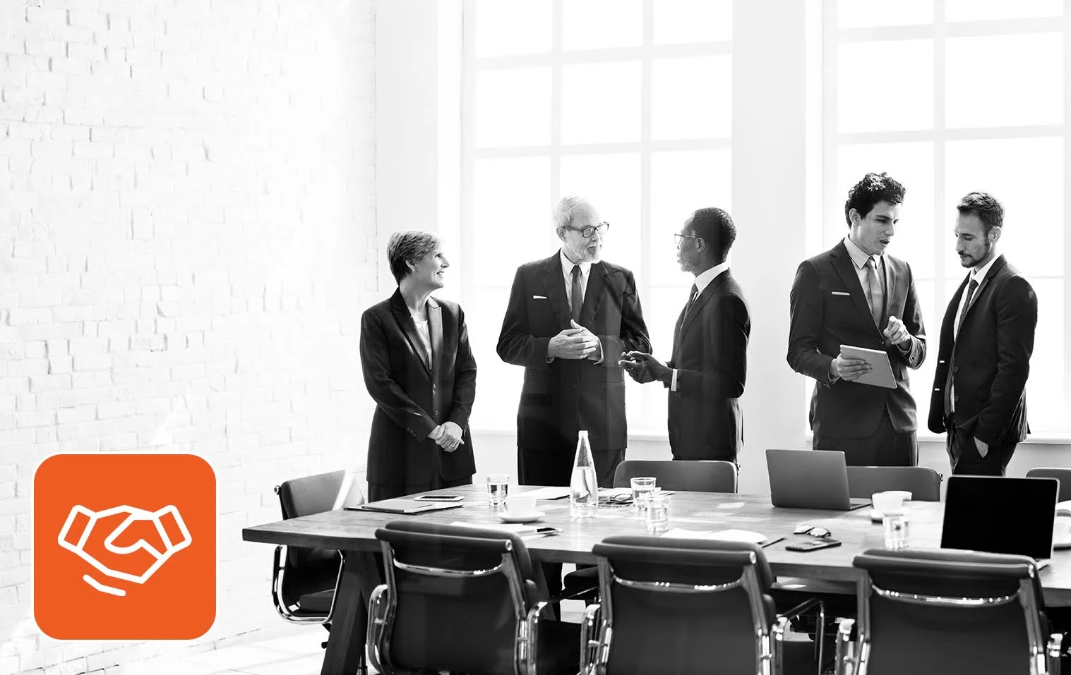 Leadership team meeting in a boardroom after a successful executive search for startups.