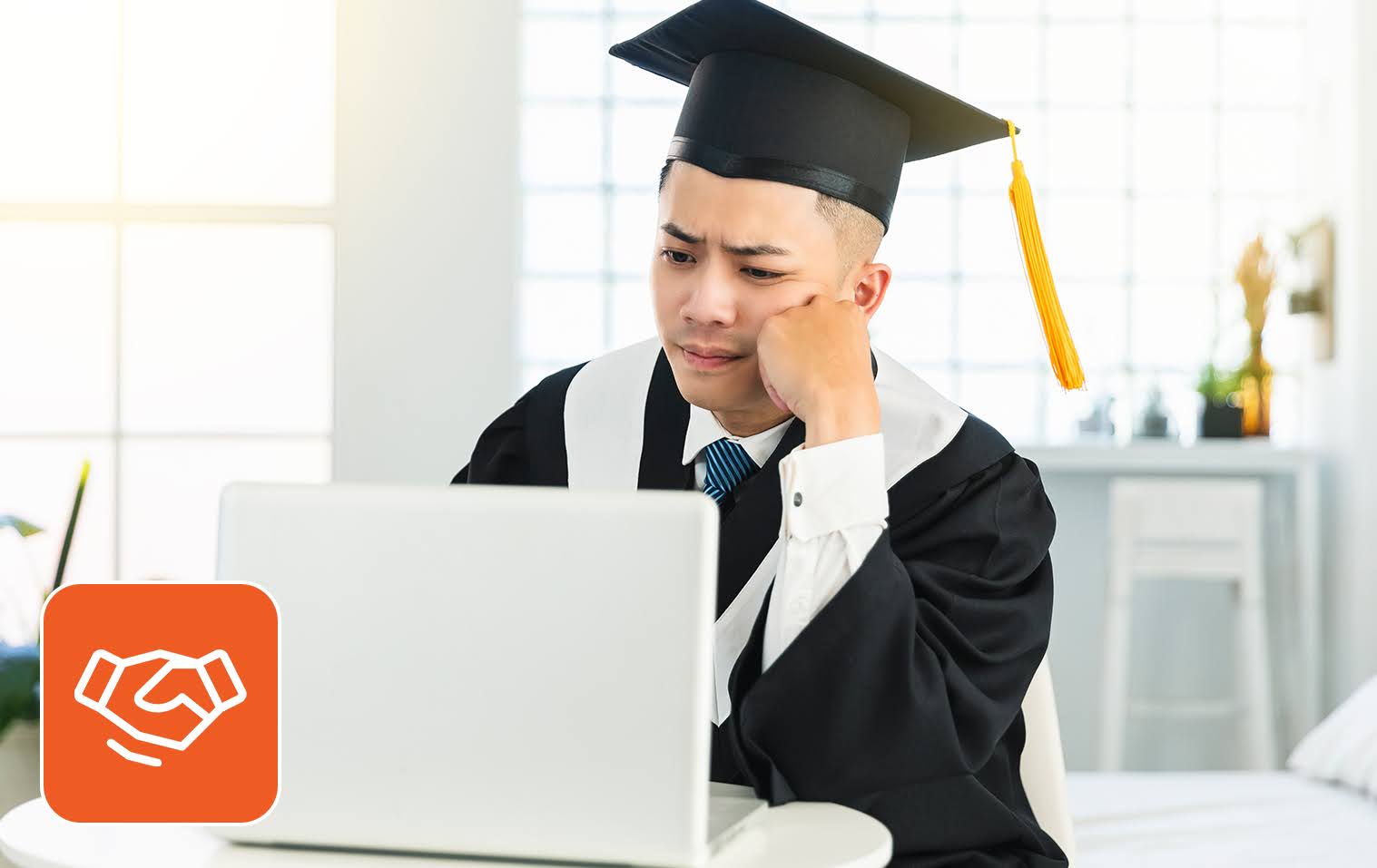Skill-based hiring concept: Frustrated man in graduation cap looking into his laptop