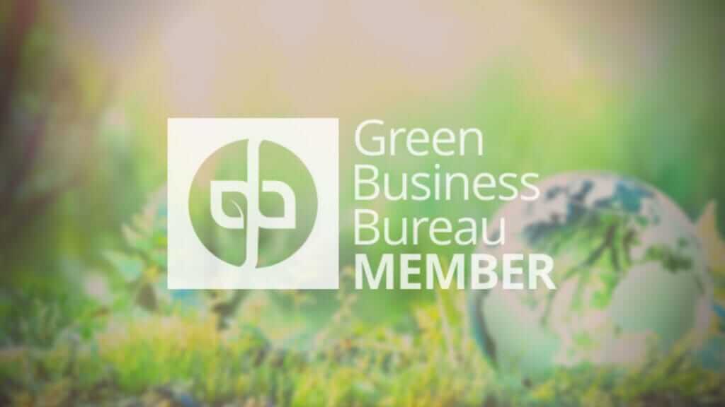A blurred green and yellow background features the logo and text of the Green Business Bureau. The logo consists of two intertwined leaves forming a circular shape, with "Green Business Bureau MEMBER" written to its right. Demonstrating leader characteristics, a small globe is faintly visible in the background.