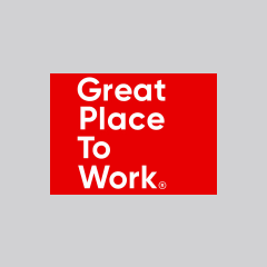 A red rectangle with the text "Great Place To Work" in white, sans-serif font, aligned to the left. The background is light grey. The text is stacked with each word on a separate line.