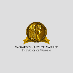 The image is a gold emblem with a profile of a woman's face in a circle. There is a gold ribbon below the circle. Below the emblem, the text reads "Women's Choice Award® - The Voice of Women" on a light gray background.