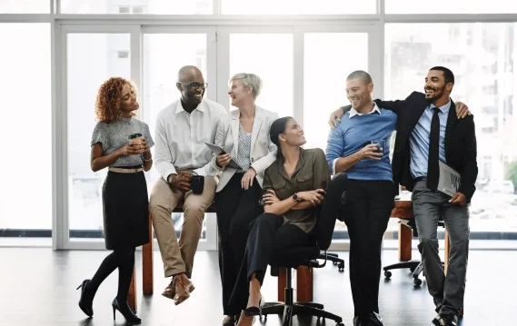 A diverse team enjoying a light moment at the office.