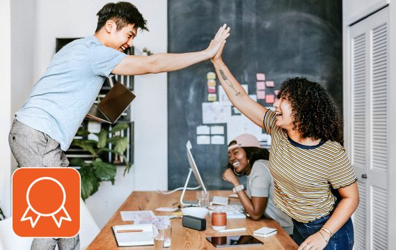 Teammates high-fiving in a joyous mood