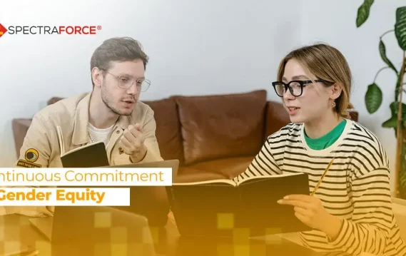 Man and woman in discussion in a cozy setting, focused on promoting gender equity in a business context.