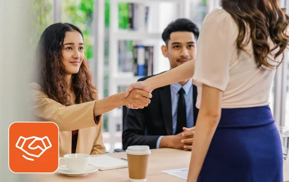 Recruiter shaking hands during a job interview reflecting current hiring trends.