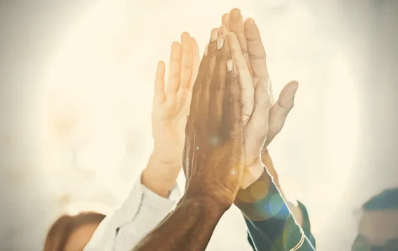 Hands raised in applause, symbolizing recognition and celebration of SPECTRAFORCE's excellence, as honored by KellyOCG®.