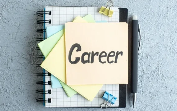 seamless-job-change Notebook with grid pattern, pastel sticky notes, and a pen, featuring a prominently displayed note labeled 'Career.'