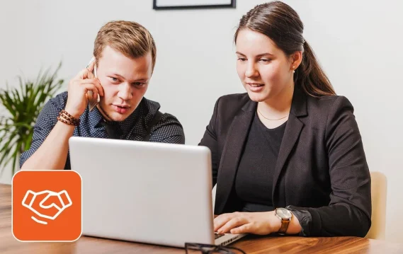 staff-augmentation-vs-managed-services Two professionals discussing workforce needs