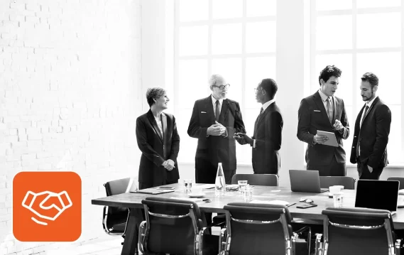 startup-c-suite-executive-search Leadership team meeting in a boardroom after a successful executive search for startups.